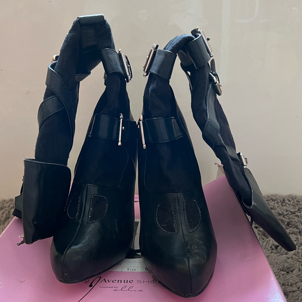 Knee high, black heeled buckled boots.  Size 9 fits small.